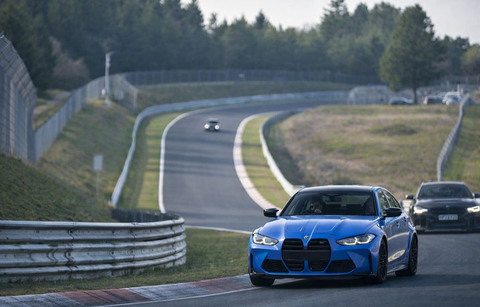 G80 M3 mid-corner on the Nordschleife with another car ahead in the distance